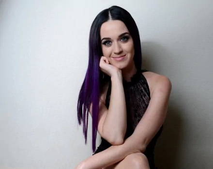 A HD desktop wallpaper featuring a smiling singer with blue eyes and long purple hair.