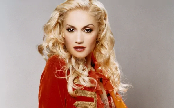 HD desktop wallpaper featuring Gwen Stefani with platinum blonde hair and a red jacket, highlighting her iconic music style and bold presence.