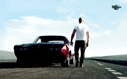 Vin Diesel as Dominic Toretto stands confidently on an empty road beside a sleek car, capturing the adrenaline of Fast & Furious 6 in this striking HD wallpaper.
