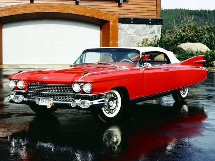 HD desktop wallpaper showcasing a shiny red 1959 Cadillac Eldorado convertible parked on a wet driveway in front of a modern house.