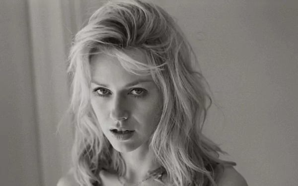 Black and white HD desktop wallpaper featuring a close-up portrait of celebrity Naomi Watts with tousled hair and an intense gaze.