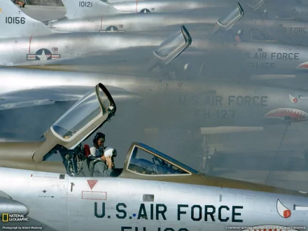 HD PC desktop wallpaper of U.S. Air Force Republic F-105 Thunderchiefs, close-up of an open cockpit with aircrew and nearby fuselages bearing USAF markings.