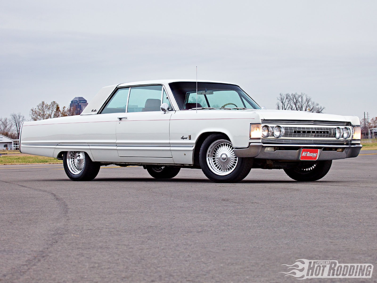 1967 Chrysler Imperial Crown Coupe showcased in high definition, captured as a sleek vintage vehicle on an open road for a PC desktop wallpaper.