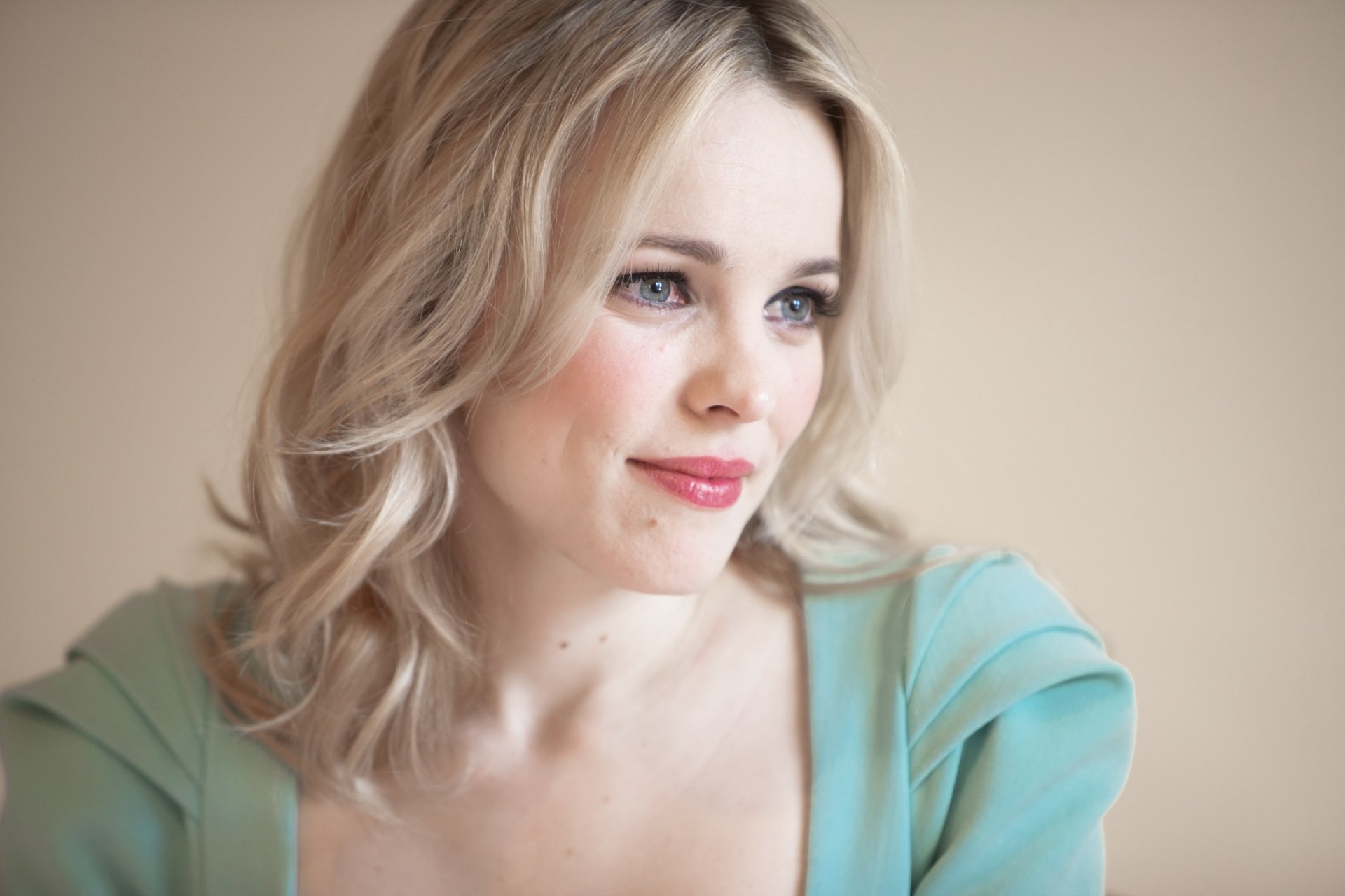 A stunning HD desktop wallpaper featuring celebrity Rachel McAdams, capturing her serene expression with soft lighting and a gentle color palette.