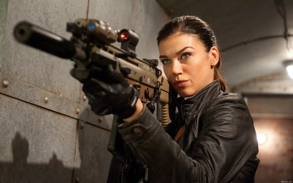 A woman in a black leather jacket aims an FN SCAR rifle equipped with a laser, set in an industrial backdrop, inspired by G.I. Joe: Retaliation. HD wallpaper for PC.