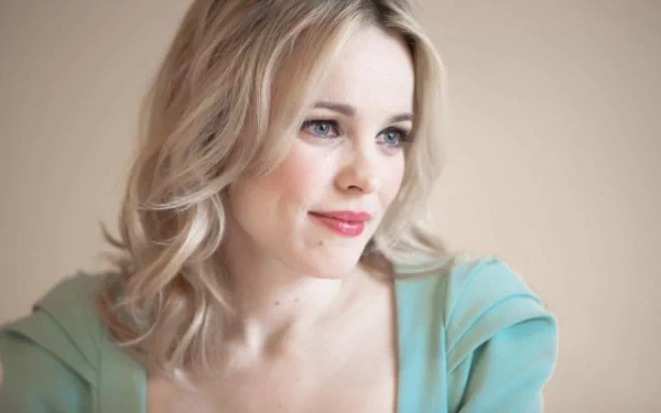 A stunning HD desktop wallpaper featuring celebrity Rachel McAdams, capturing her serene expression with soft lighting and a gentle color palette.