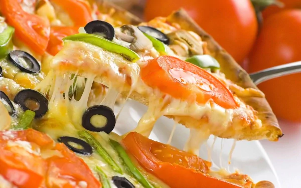 A delicious, cheesy pizza topped with fresh tomatoes, olives, and green peppers, set against vibrant tomatoes, making an enticing HD desktop wallpaper.