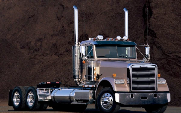 HD desktop wallpaper featuring a classic Freightliner Trucks semi-truck with chrome details against a dark textured background.