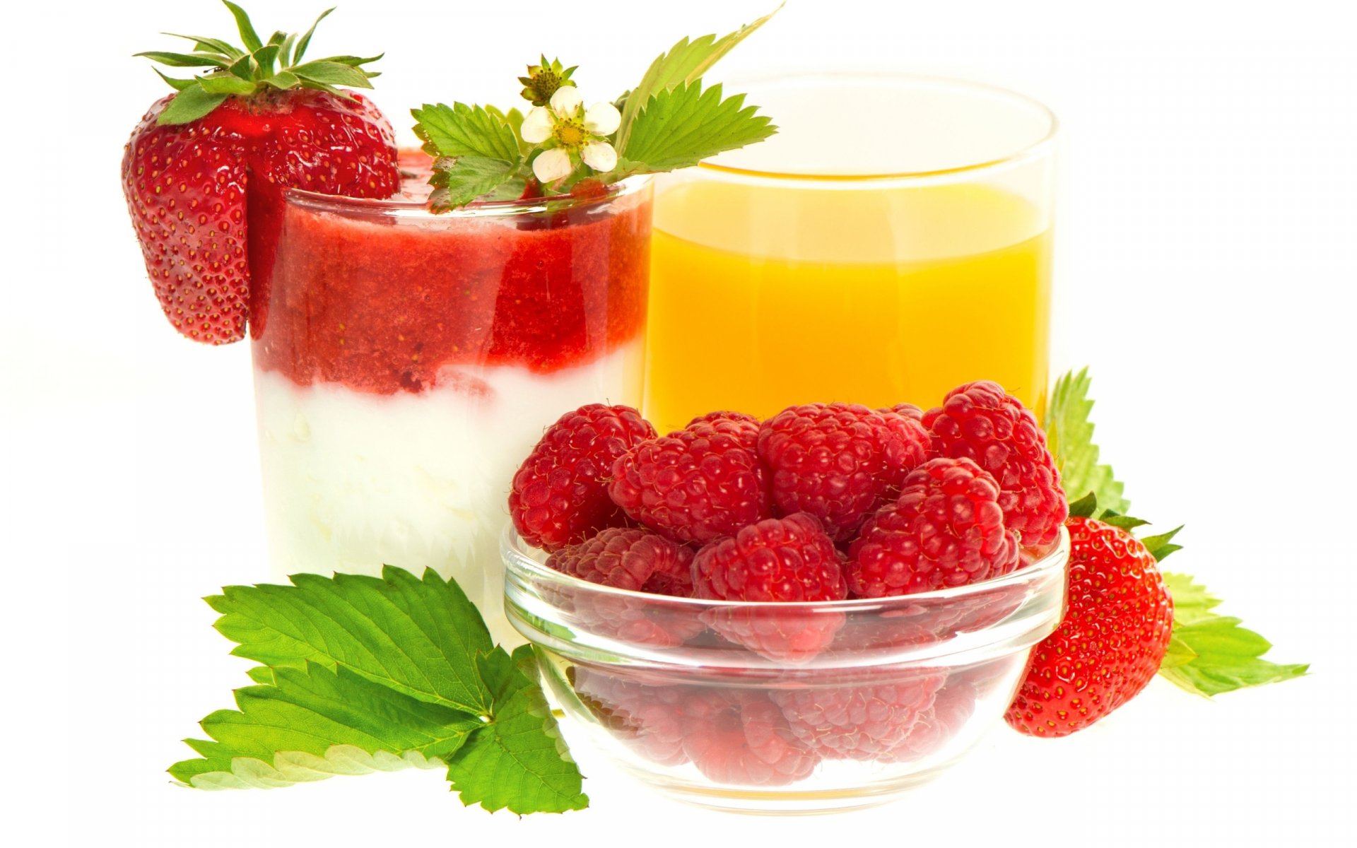 HD desktop wallpaper featuring a close-up of fresh raspberries in a glass bowl, a strawberry-topped yogurt parfait, and a glass of orange juice on a white background.