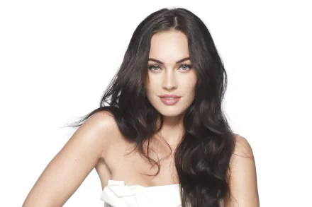 A high-definition desktop wallpaper featuring Megan Fox, showcasing her striking features and long, flowing hair against a clean, bright background.