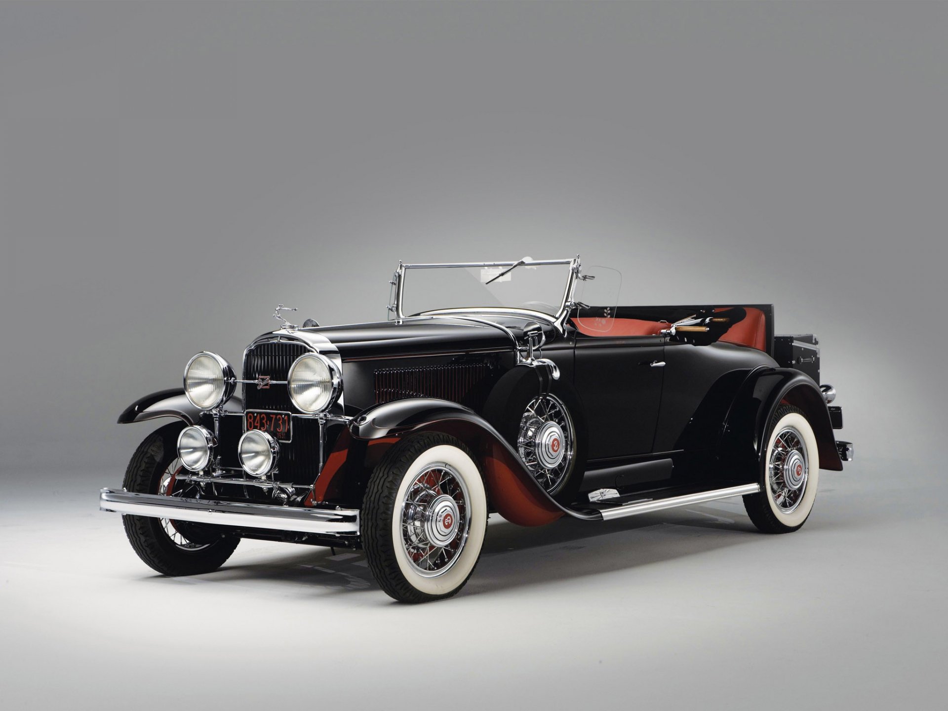 1931 Buick 94 Roadster showcased in a high-definition PC desktop wallpaper, highlighting its classic black body, whitewall tires, and vintage design details.