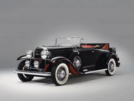 1931 Buick 94 Roadster showcased in a high-definition PC desktop wallpaper, highlighting its classic black body, whitewall tires, and vintage design details.