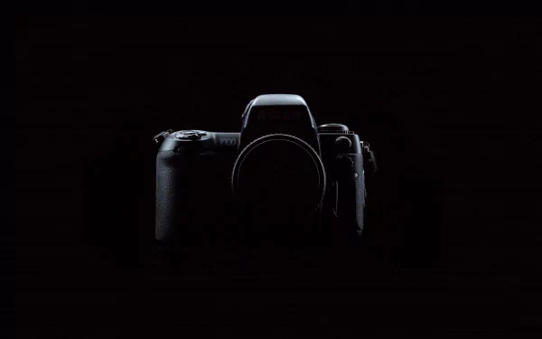 A sleek camera stands out against a dark background, creating an artistic focal point for a high-definition PC desktop wallpaper.