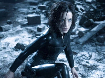 HD PC desktop wallpaper featuring a scene from the movie Underworld: Evolution, showing the protagonist in a dark, snowy, and ruined environment.