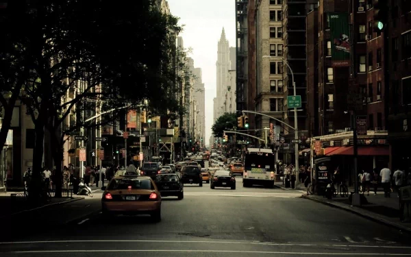 HD desktop wallpaper featuring a bustling New York street with vehicles and pedestrians, capturing the city's vibrant essence.
