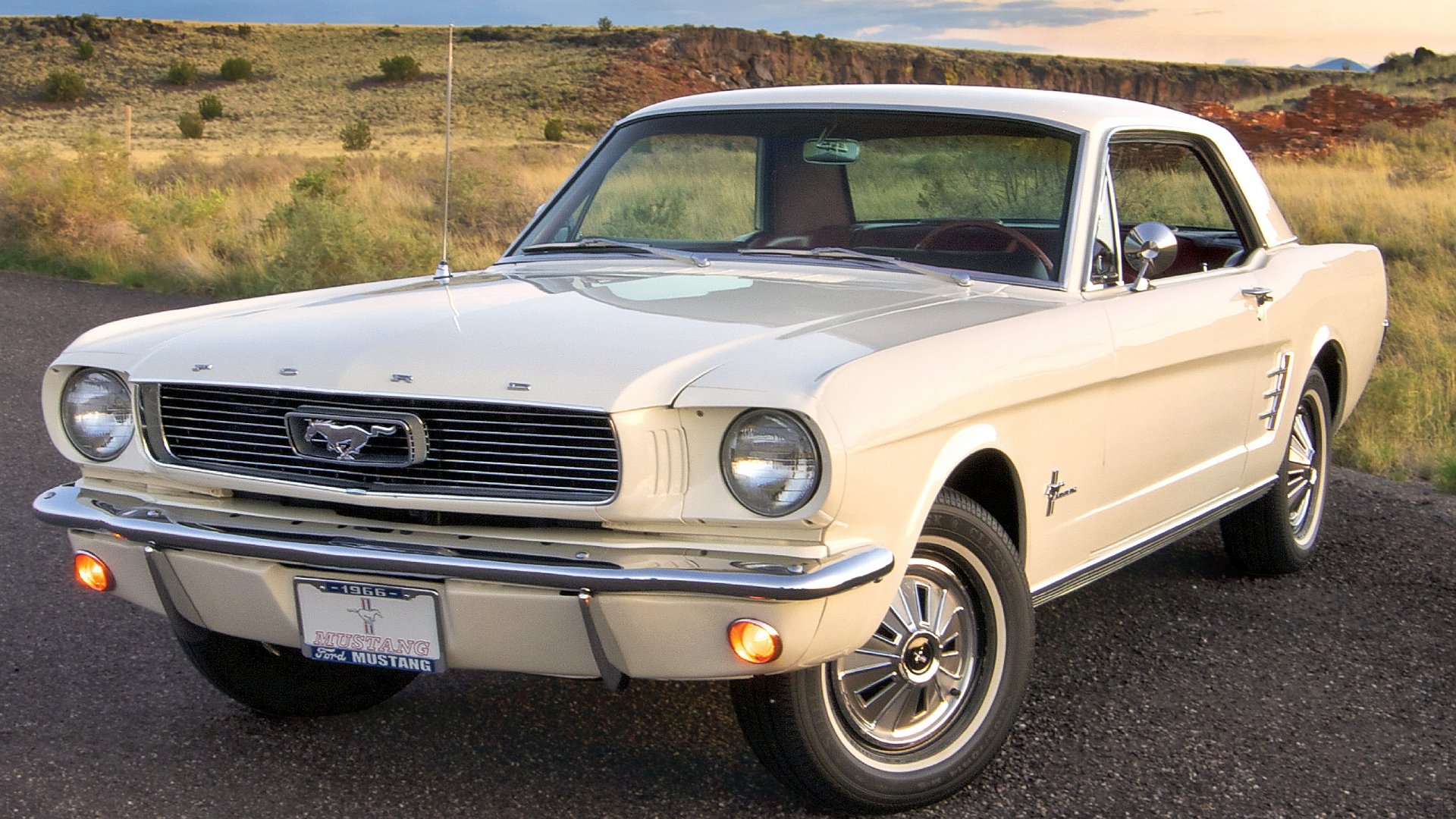 Classic white Ford Mustang vehicle parked on a rural road, presented as a 2K Quad HD PC desktop wallpaper and background.