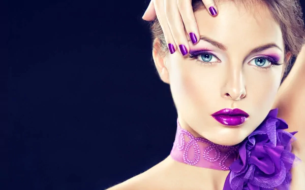 A striking close-up of a woman with a glamorous look, showcasing bold makeup and purple accents. This HD image serves as a vibrant desktop wallpaper and background.