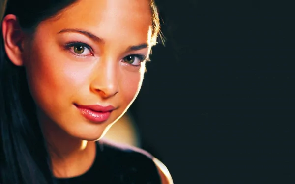 HD PC desktop wallpaper featuring a close-up portrait of celebrity Kristin Kreuk with a dark background.