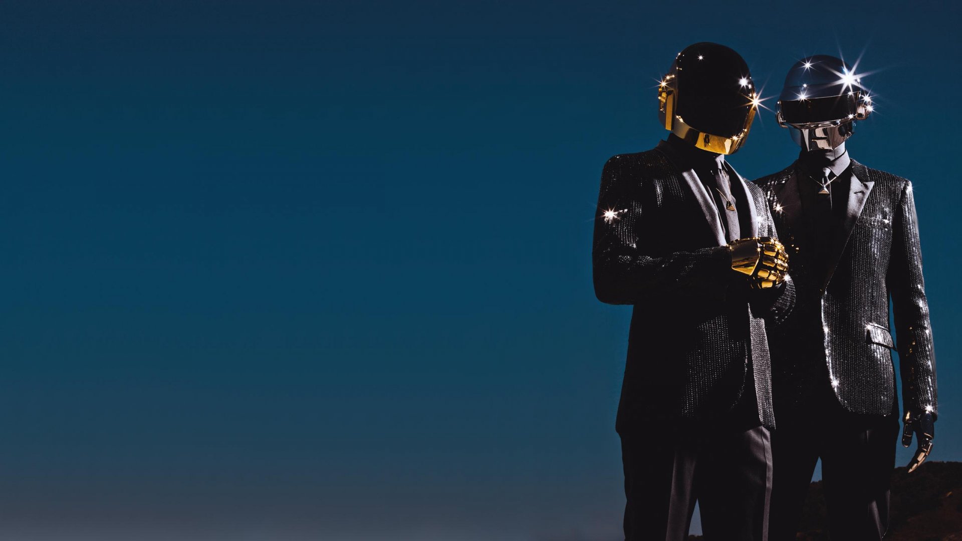HD desktop wallpaper featuring Daft Punk members in their iconic helmets and suits against a dark blue background, capturing the essence of electronic music.