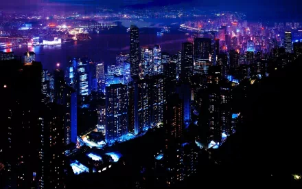 HD desktop wallpaper of Hong Kong's cityscape at night with illuminated skyscrapers and Victoria Harbour in the background.