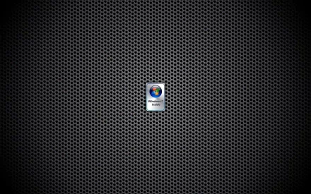 HD desktop wallpaper featuring a dark, textured metallic grid background with a centered Windows 7 logo, highlighting technology and classic PC design.