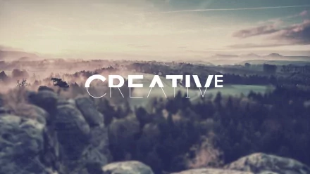 A serene landscape features softly blurred rocks and trees in the background, with the word CREATIVE boldly displayed in the foreground, creating an artistic and inspiring HD desktop wallpaper.
