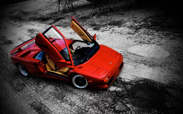 HD PC desktop wallpaper featuring a red Lamborghini Diablo with scissor doors open, set against a textured, cracked asphalt background.