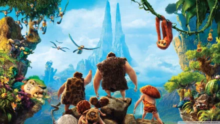 HD PC desktop wallpaper featuring characters from the movie The Croods overlooking a vibrant prehistoric landscape with lush greenery and towering rock formations.