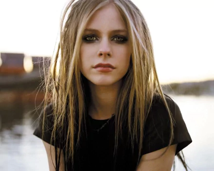 HD desktop wallpaper of Avril Lavigne, with a serene outdoor background, tagged with music.