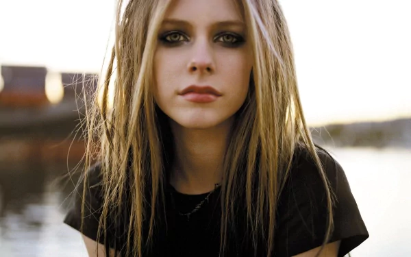 HD desktop wallpaper of Avril Lavigne, with a serene outdoor background, tagged with music.