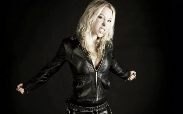 HD PC desktop wallpaper of a fierce woman in a black leather jacket, representing the music band Arch Enemy.