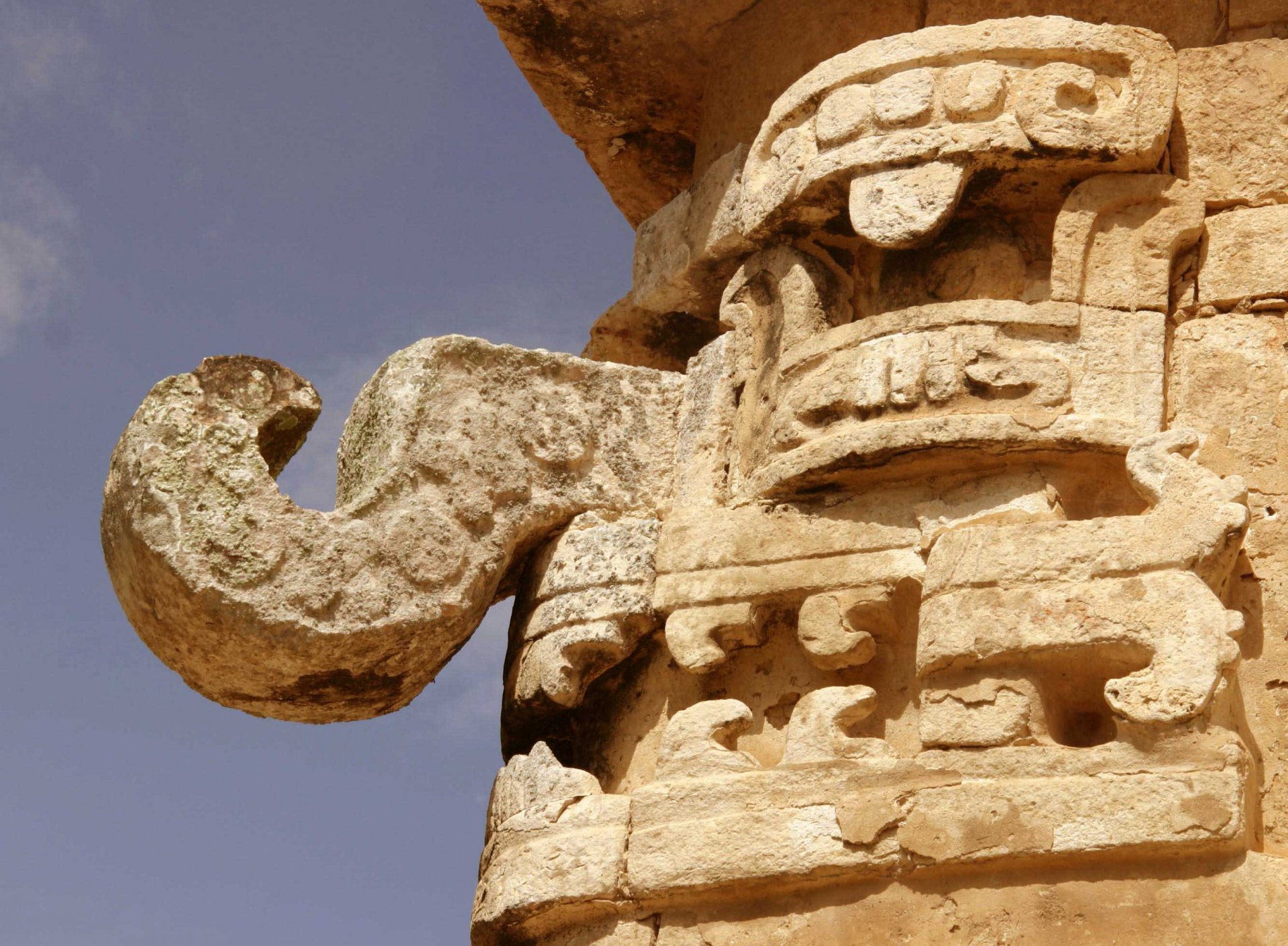 Close-up detail of intricate stone carvings at the man-made Chichen Itza, featured in an HD PC desktop wallpaper and background.