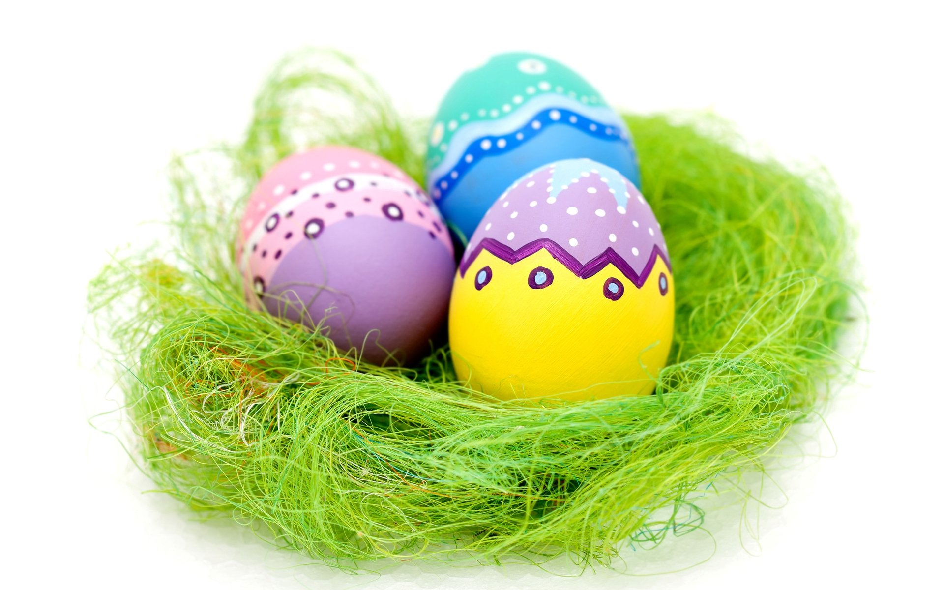 Colorful Easter eggs in a vibrant green nest, creating a cheerful holiday scene. This HD wallpaper captures the essence of Easter celebrations.