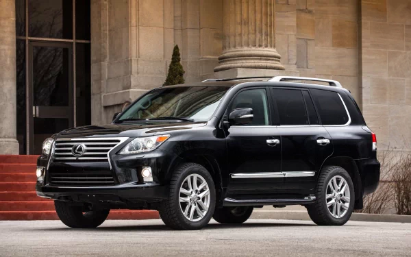 HD PC desktop wallpaper featuring a sleek black Lexus LX 570 SUV parked in front of a grand building, showcasing the luxury and design of the Lexus vehicle.