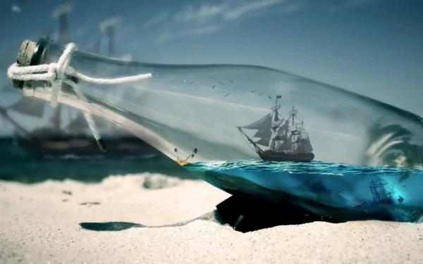 A ship inside a bottle rests on sandy shores, with a beautiful blue ocean beneath it. This HD image serves as an engaging desktop wallpaper and background.