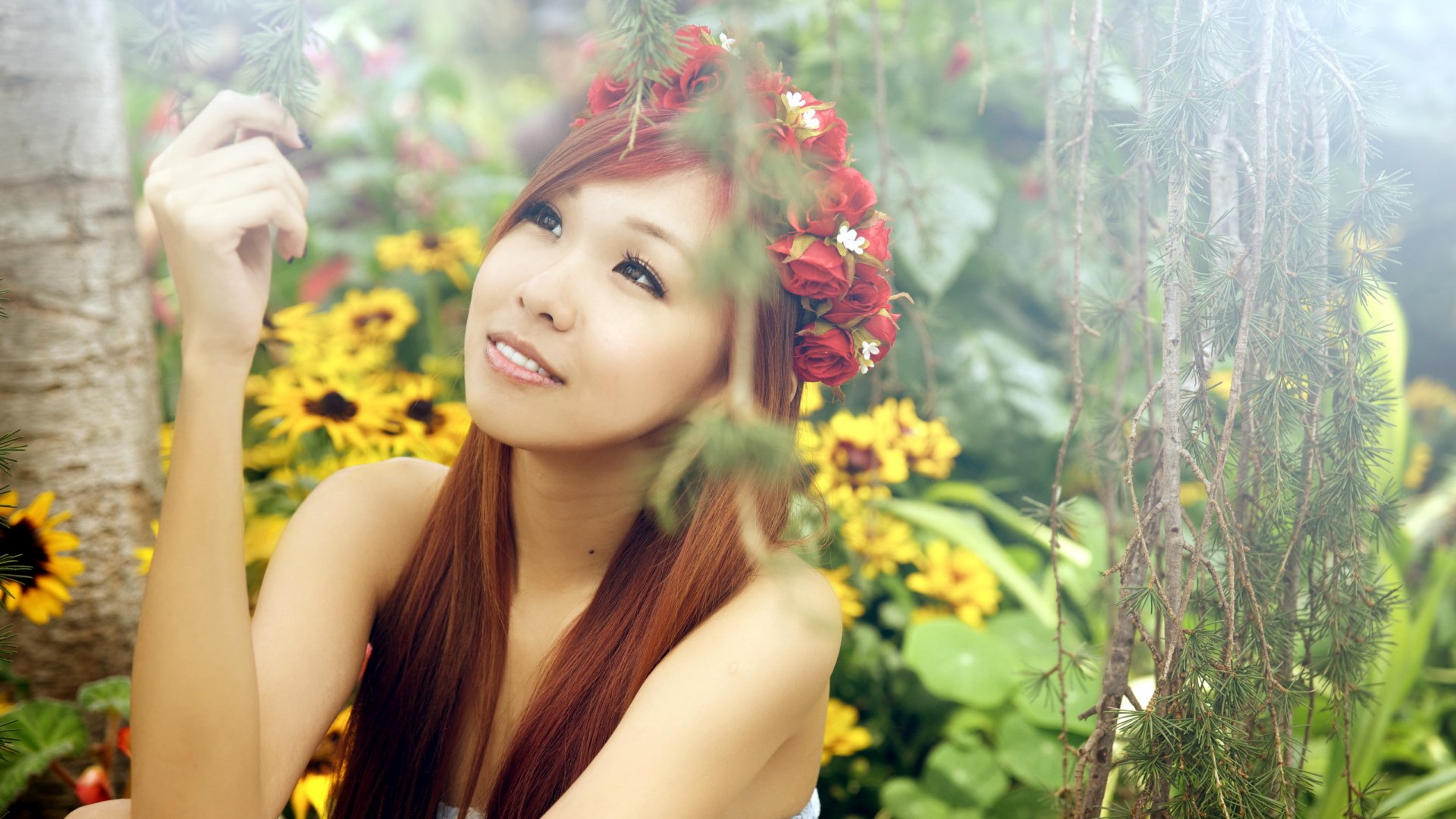 HD desktop wallpaper featuring an Asian woman with a floral crown, surrounded by vibrant yellow flowers and greenery in a serene outdoor setting.