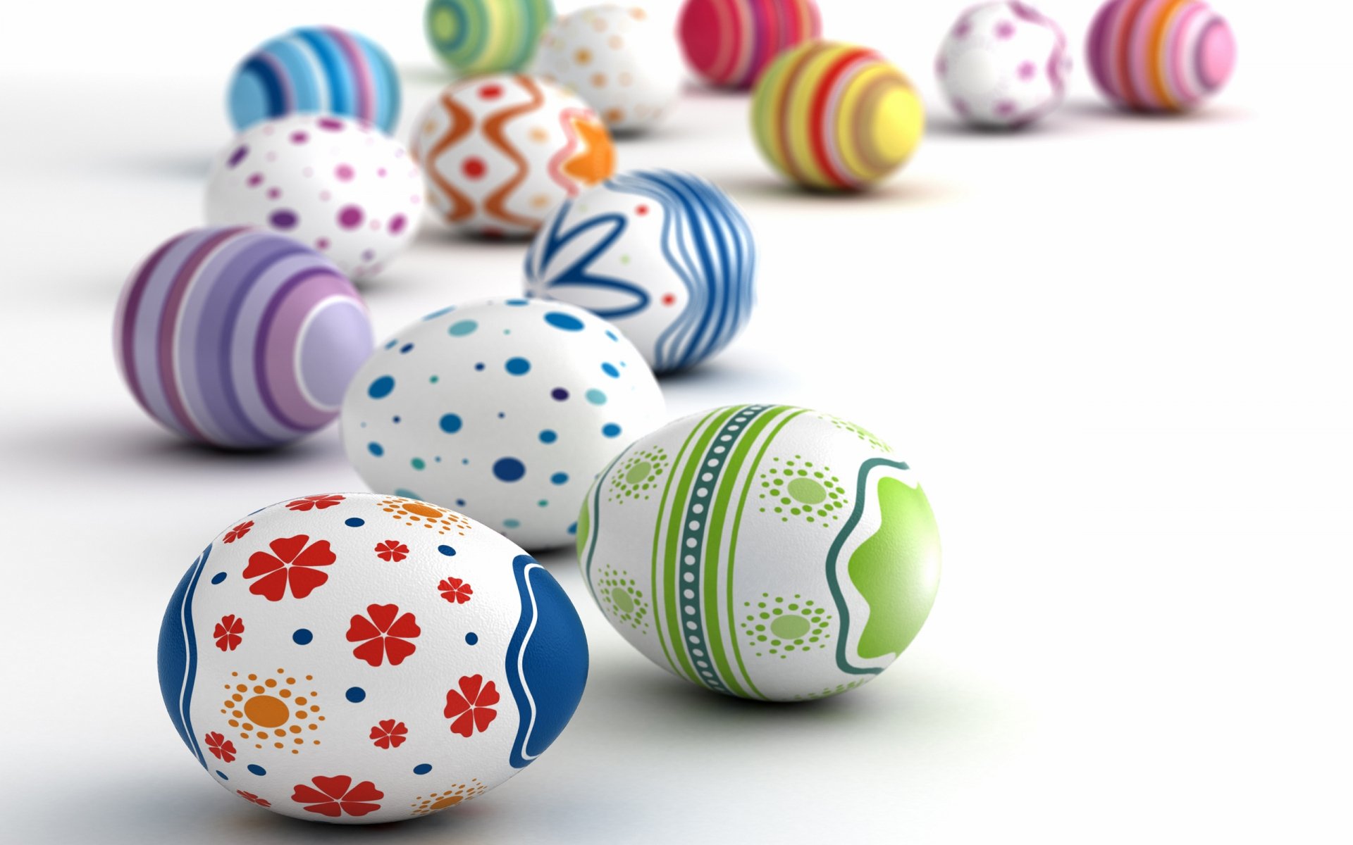 Colorful decorative Easter eggs in various patterns and colors are scattered across a white background, creating a vibrant and festive holiday-themed HD wallpaper.