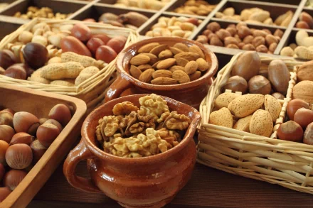 A vibrant display of various nuts in baskets and bowls, showcasing a rich assortment that celebrates the diversity of food. This 4K Ultra HD image serves as a stunning desktop wallpaper.