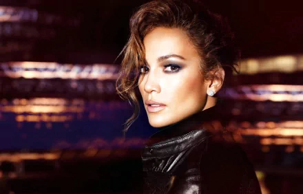 A stunning HD desktop wallpaper featuring Jennifer Lopez, showcasing her captivating gaze and stylish look against a blurred urban backdrop.