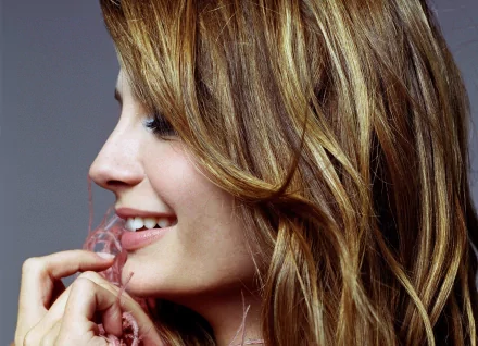 Close-up profile of celebrity Mischa Barton smiling, captured in a 4K Ultra HD desktop wallpaper and background.