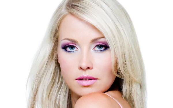 A close-up of a woman with long blonde hair and striking makeup, featuring beautiful blue eyes. This HD image serves as a captivating desktop wallpaper or background.