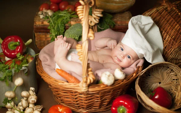 A high-resolution 4K Ultra HD photo of a baby wearing a chef's hat, lying in a basket surrounded by fresh vegetables and mushrooms, creating a vibrant kitchen scene.