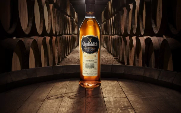 A captivating image of a whisky bottle, set against a backdrop of wooden barrels, showcasing rich colors and textures for a sophisticated food and drink atmosphere. HD wallpaper.