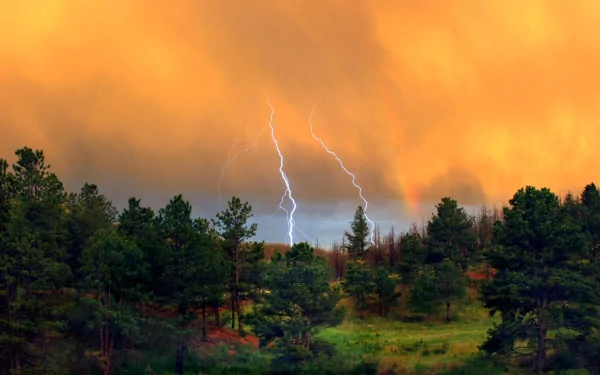 A dramatic scene featuring vibrant lightning striking through intense orange skies, set against a backdrop of lush green forests. High-definition photography for PC wallpapers.