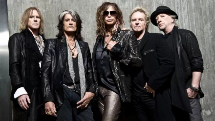 A high-definition wallpaper featuring the iconic rock band Aerosmith, with Steven Tyler and fellow members posing in stylish attire against a textured backdrop.