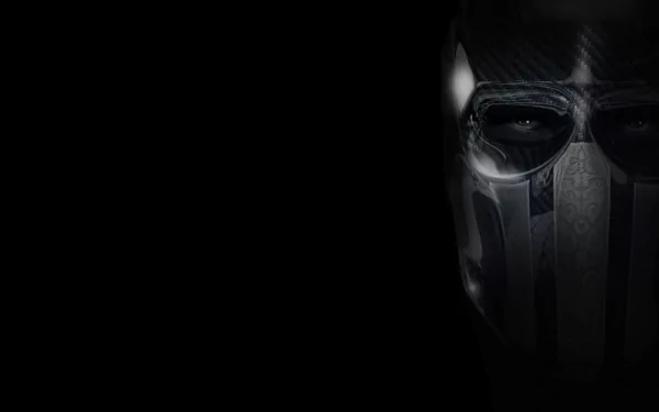 HD PC desktop wallpaper from the video game Army of Two: close-up of a tactical soldier's dark metallic mask emerging from black background.
