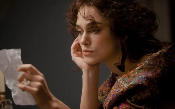 HD desktop wallpaper featuring a contemplative scene from the 2012 movie Anna Karenina, showcasing the lead character in period costume.