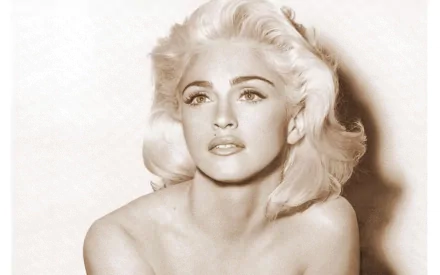A striking black-and-white portrait of Madonna, featuring her iconic blonde hair and expressive gaze, serves as an eye-catching HD PC desktop wallpaper and background.