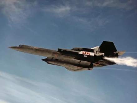 HD desktop wallpaper featuring the Lockheed SR-71 Blackbird military aircraft soaring against a blue sky backdrop.