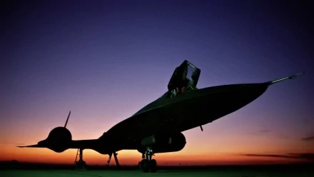 Silhouetted against a vibrant sunset, the Lockheed SR-71 Blackbird exudes power and elegance, showcasing its distinctive design as a striking military aircraft wallpaper.